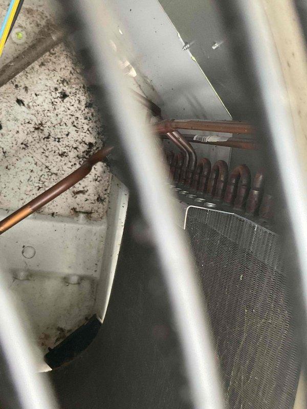 Diagnosed AC system exhibiting no cooling and found refrigerant leak at condenser coil with infrared leak detector, verified by visible water dripping into furnace. Replaced defective condenser coil to restore proper system operation and cooling capacity.