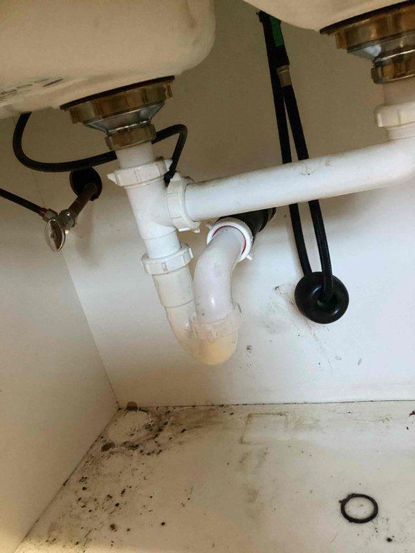 Responded to customer complaint of musty odor and suspected water leak under pantry. Upon inspection, identified water damage and mold growth under sink cabinet resulting from improper washing machine drainage. Performed visual assessment of water heater and heating system to rule out additional sources of moisture.