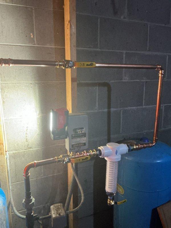 Diagnosed and resolved low hot water pressure at kitchen faucet caused by sediment accumulation in the plumbing lines. Installed whole-house sediment filter to address ongoing water quality issues from the customer's well water system, effectively restoring proper flow to both hot and cold water sides of the kitchen faucet.