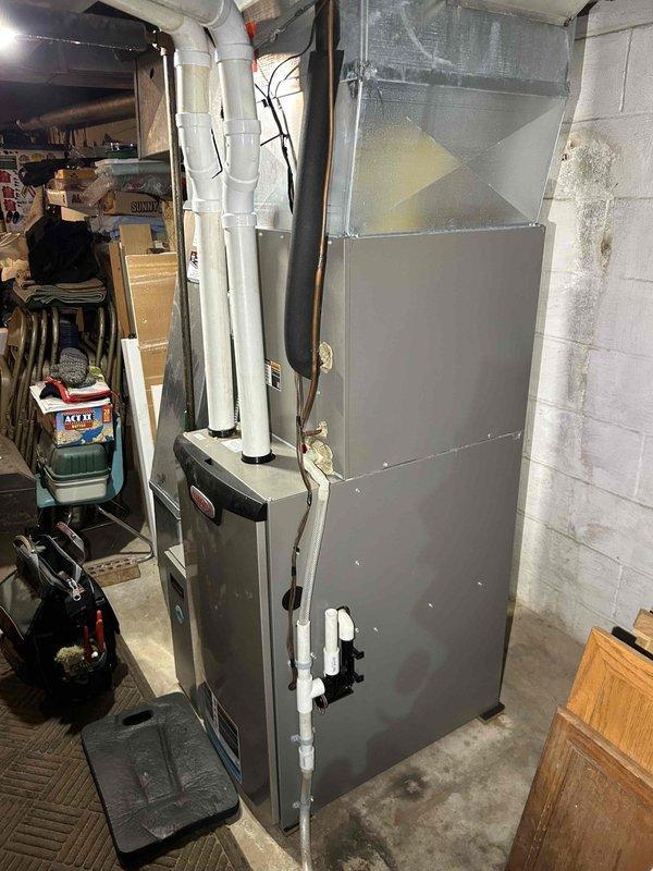 Performed comprehensive furnace tune-up on a unit that had not been operated for 2 years. Inspection revealed properly functioning system with normal operation. Services included heat exchanger inspection, combustion analysis testing, gas pressure verification (both high and low stage), flame sensor and burner inspection, and blower motor evaluation. Secured condensate tube connection after clearing water buildup. Air filter in moderate condition, pressure switch cleaned. Thermostat confirmed operational with adequate heating performance. No immediate concerns identified.