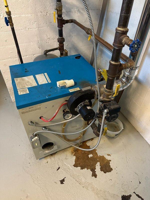 Performed routine tune-up on 20-year-old Slant/Fin water boiler. Diagnosed and addressed water leakage from relief valve caused by excessive system pressure (~30 psi). Adjusted auto fill valve, set pressure to approximately 15 psi, cleaned burners, and verified system stabilized at 18 psi when heated to 160°F. Customer advised to monitor pressure, with possible future expansion tank or relief valve replacement if issues persist.