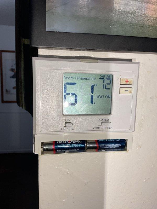 Responded to no heat complaint at customer's café. Diagnosed York furnace showing fault code 57 (pressure switch failure) that persisted even in fan-only mode. Found severely clogged 14x14x1" filter that customer was unaware of, significant water accumulation around unit from leaking water heater, and evidence of multiple previous repairs. After unsuccessful attempts to jump terminals and power the blower with 24V, customer was advised to contact plumber for water heater leak and schedule follow-up for either component replacement or full system replacement consultation.
