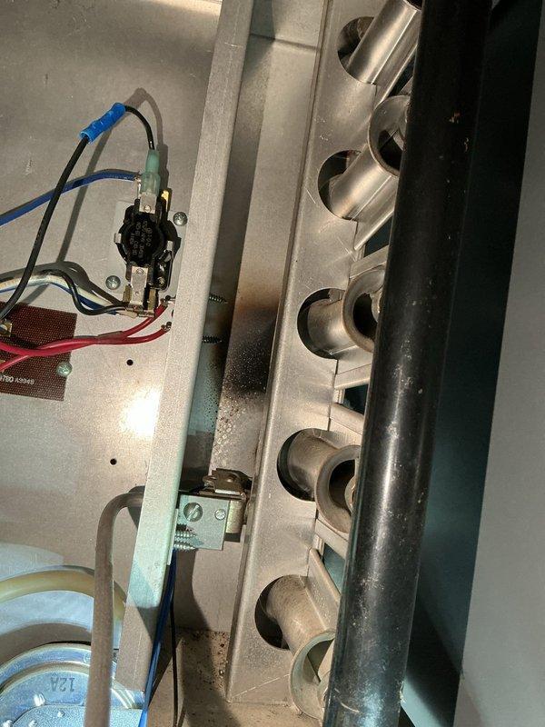 Responded to customer report of no heat from Sterling RF-75 gas garage heater. Diagnosed two critical issues: loose R wire connection at thermostat and flame rollout from compromised heat exchanger. Due to safety concerns with the flame rollout condition and visible damage to heat exchanger components, recommended and completed full replacement of the garage heating unit to restore safe heating functionality.