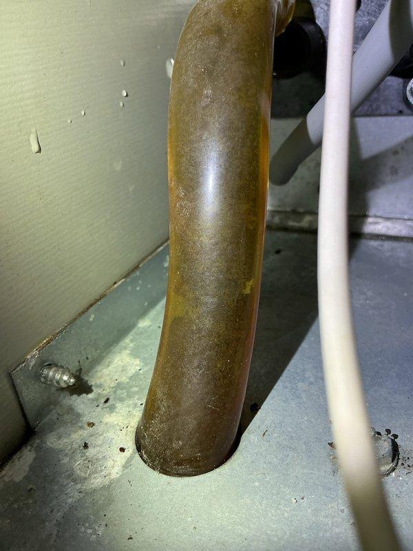 Diagnosed 21-year-old natural gas furnace failing to maintain set temperature despite recent filter change. Found plugged condensate line causing pressure switch failure and high limit switch shorting on heat exchanger. Serviced system by cleaning condensation drain line and repositioning high limit switch. System now functioning properly and maintaining desired temperature.