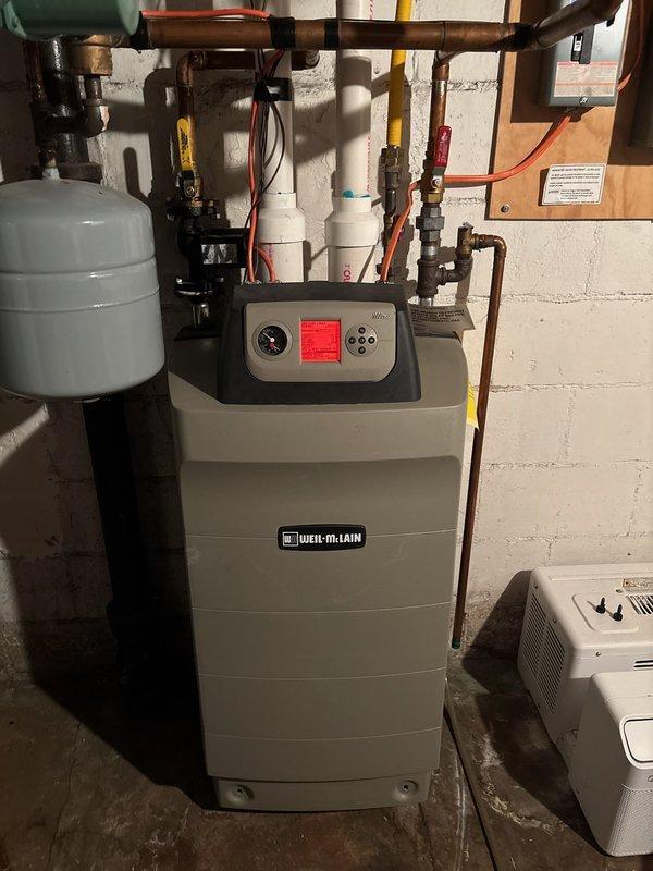 Responded to no-heat call for 10-year-old LP boiler system displaying ignition fault/lockout. Discovered severely plugged heat exchanger which was cleaned as part of a maintenance kit installation. After cleaning, identified and resolved combustion issues likely caused by either gas mixture changes following recent LP tank filling or previous throttle screw adjustment. Made necessary throttle screw adjustments to properly calibrate combustion on both low and high fire. Verified proper system operation for 20 minutes with stable ignition and performance restored.