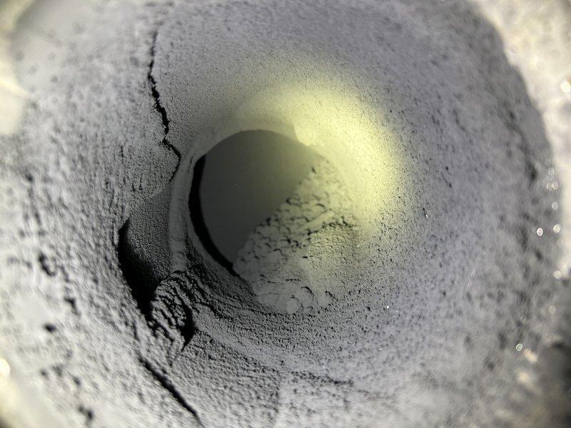 Inspected oil furnace after customer reported soot throughout house following service by another company. Found incorrect nozzle size had been installed previously, causing extensive soot accumulation in mechanical room, clean-outs, burn chamber, and chimney. Tagged out and shut down furnace due to safety hazards from improper venting through baro damper. Advised customer that heat exchanger replacement would be required and recommended chimney cleaning; scheduled consultation for gas furnace conversion options.