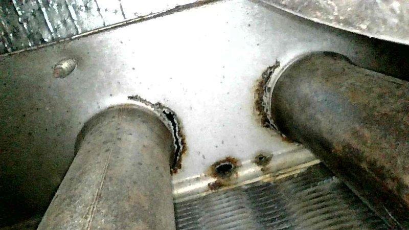 Responded to no heat call for 20+ year old Amana system. Inspection revealed multiple cracks and holes in the heat exchanger, which was confirmed by visible corrosion and deterioration around pipe connections. Due to safety concerns, system was shut down and emergency service scheduled for 8am following day. Owner was present during diagnosis and was shown the damaged components.