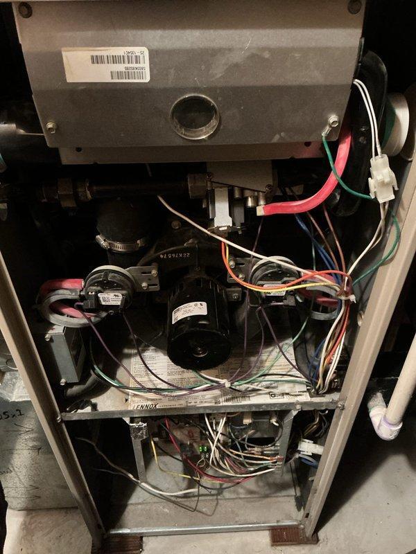 Responded to no heat call for 8-12 year old furnace that was blowing cold air after temperature adjustment. Upon inspection, identified a failed inducer motor and cracked heat exchanger as the root causes. Due to safety concerns and extent of damage, recommended complete furnace replacement as repair was not viable.