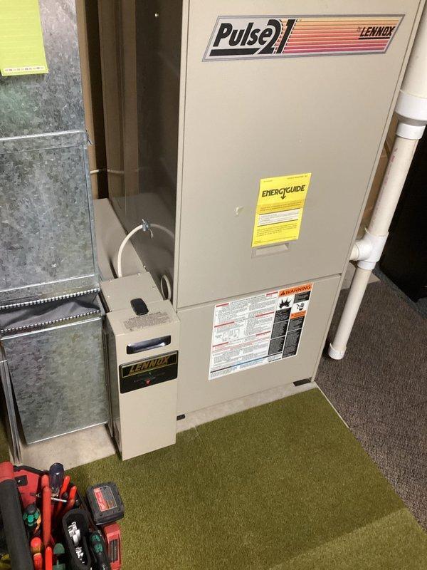 Responded to no heat call for Lennox Pulse 21 LP furnace in lockout condition. Inspection revealed loose hose on pressure switch causing system failure. Reattached hose, cycled power, and confirmed proper ignition sequence. Verified normal thermostat operation and proper fan control cycling. System now operating normally with all components functioning correctly.