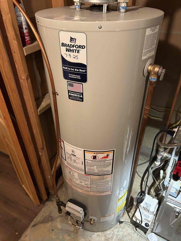 Returned to complete installation of PSC draft combustion inducer blower assembly on Bradford White water heater. Successfully installed and connected the inducer motor with proper electrical wiring, restoring normal operation to the unit's combustion system.