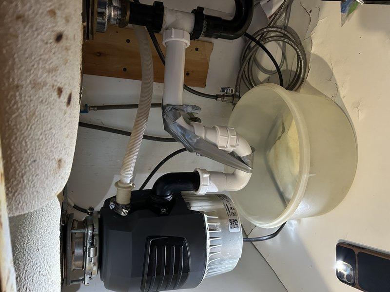 Removed unnecessary second trap that was causing garbage disposal to leak during operation. Properly replumbed disposal unit into existing plumbing system, eliminating vibration issues that were previously causing pipe disconnection. Installed direct connection with proper P-trap configuration to ensure stable, leak-free operation.