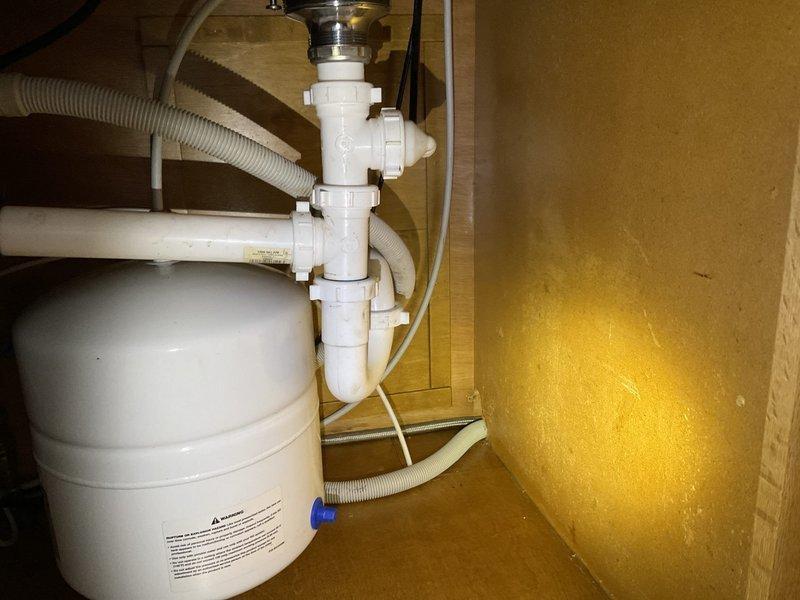 Responded to service call for kitchen sink drain not draining properly. Diagnosed issue as frozen kitchen drain piping rather than standard clog. Successfully thawed drain system using specialized homemade jetter equipment. Performed thorough flush of the drainage system to ensure proper flow was restored to the InSinkErator Evolution Excel disposal unit and associated P-trap assembly.