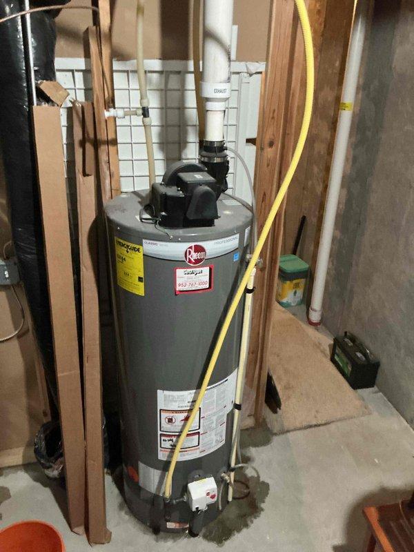 Completed water heater estimate for customer reporting a leaking unit. Inspected current Rheem water heater installed in unfinished basement area with PVC ventilation. Documented existing installation including gas line connection, pressure relief valve system, and surrounding utility infrastructure. Prepared replacement bid for new water heater installation.