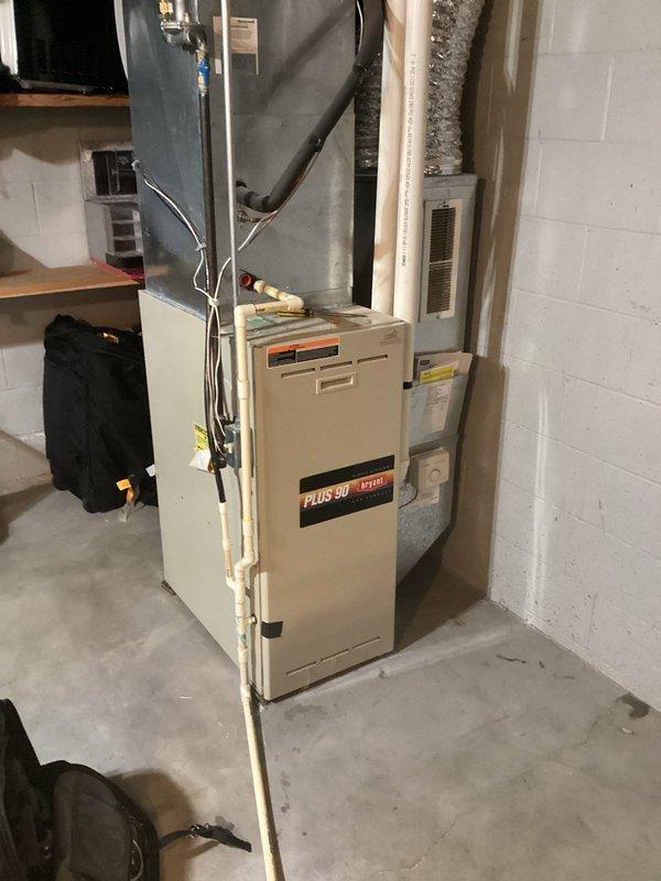 New Richmond, WI - Responded to customer report of intermittent high-pitched squealing noise from addition furnace. Diagnosed failing inducer motor bearings with high amp draw. Inspection revealed compromised secondary heat exchanger in Bryant/Carrier Plus 90 90% efficient model, presenting carbon monoxide leakage hazard. Unit red-tagged as unsafe for operation, power disconnected, and documentation provided to customer. Scheduled comfort advisor visit for replacement estimate.