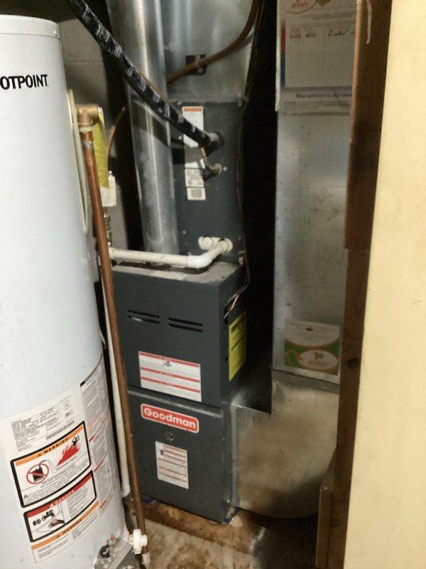 Diagnosed Hotpoint water heater leaking from bottom in utility room, identified as an internal tank leak. Unit is approximately 10+ years old natural gas model. Recommended complete water heater replacement as repair not feasible for this type of failure.