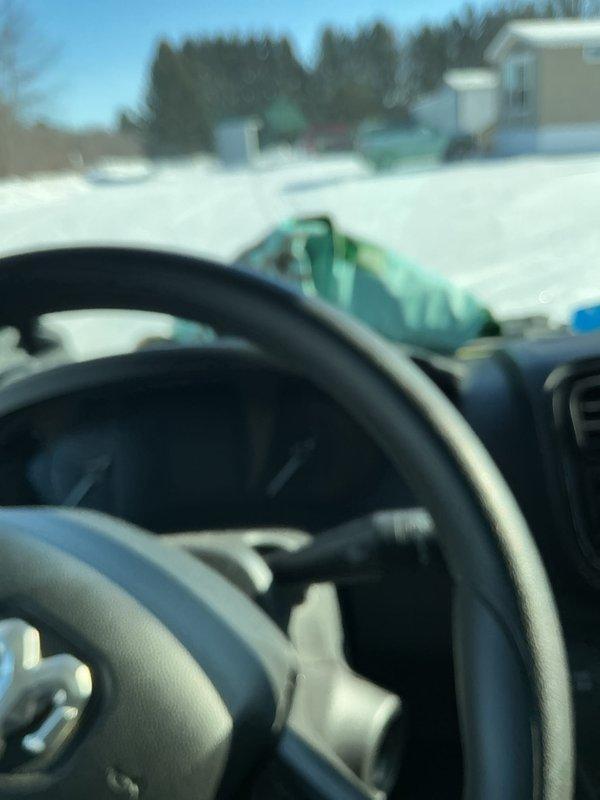 Responded to clogged drain service call at mobile home where washing machine was draining into master toilet/tub, with water leaking from toilet base. Diagnosed issue as likely frozen sewer line underneath house or plugged main. Advised customer that toilet reset would not resolve underlying drainage issue and recommended contacting specialized mobile home plumbing service with sewer main cleaning capabilities.