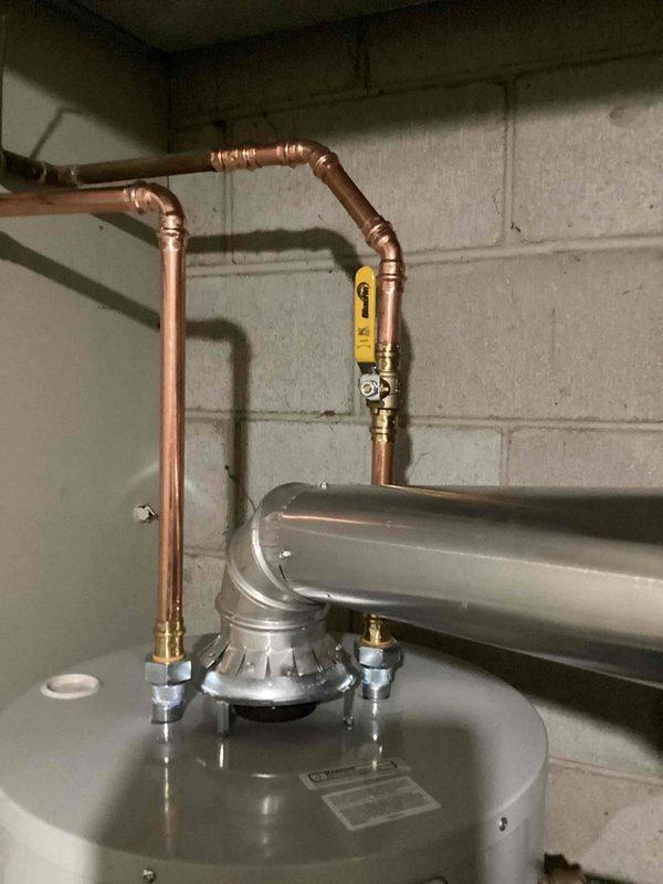 Responded to service call for water heater with pilot light failure and tank leak. Upon inspection, determined tank was compromised and unrepairable. Removed existing unit and installed new tanked water heater with proper gas line and copper pipe connections in basement utility area.