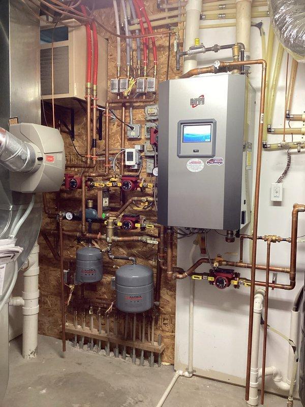 Responded to service call regarding overheating bedroom and non-functioning heated sidewalk feature. Diagnosed sidewalk heat system displaying "internal fault" error; reset system which restored proper operation and monitored for 90 minutes to confirm stability. Investigated bedroom overheating issue and determined thermostat was preventing furnace shutdown when in heating mode; verified by disconnecting thermostat wires from zone control panel which allowed heat to shut off correctly. Recommended replacement thermostat to homeowner to resolve bedroom temperature control issues.