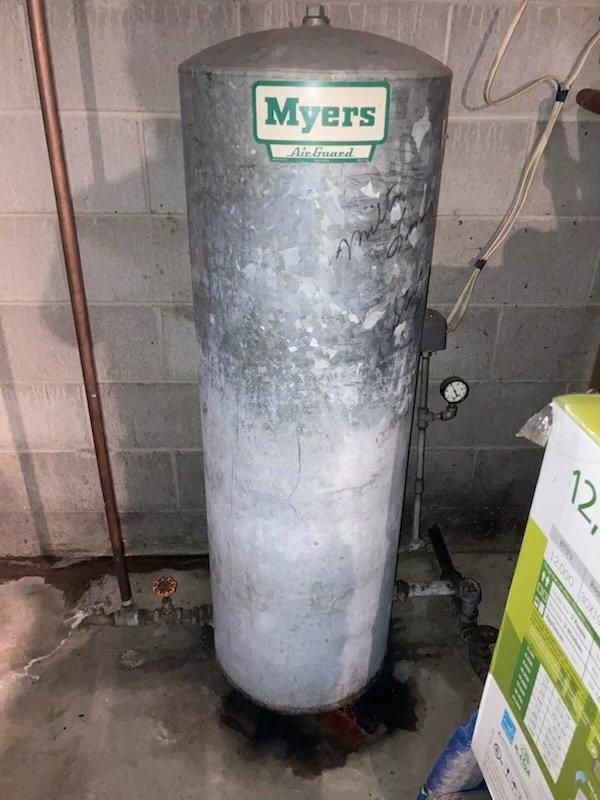 Replaced customer's aging pressure tank with new Myers Air Guard model and installed code-compliant upgrades to the plumbing system. Verified proper pressure gauge operation and inspected connections for leaks after installation. Customer advised this is a vacation property requiring advance notice for future service visits.