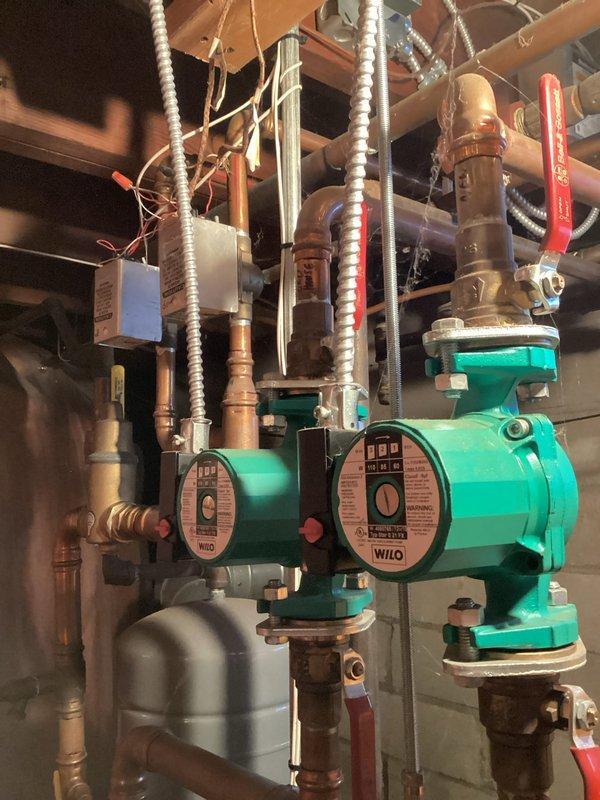 Performed annual tune-up on combination heating system. Serviced mini-split units by cleaning filters and verifying proper heating operation. Conducted boiler maintenance including burner removal and cleaning, heat exchanger inspection, and confirmation of proper water flow and heating function during 20-minute operational test. Documented equipment details including Wilo circulation pumps and electrical panel configuration for system records. Customer advised about future mini-split cleaning for downstairs unit.