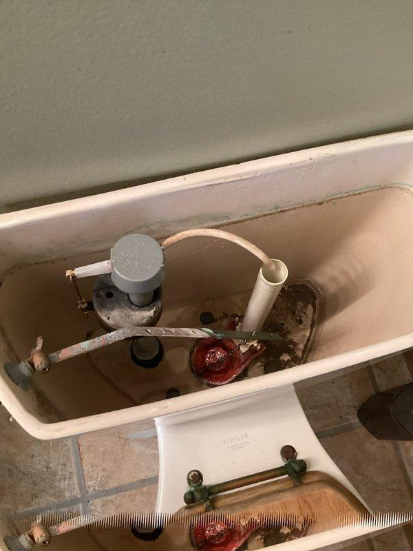 Responded to water leak service call for a toilet valve issue. Upon inspection, identified a leaking fill valve and deteriorated flapper in the toilet tank showing mineral buildup and aging. Replaced both the fill valve and flapper to restore proper function and eliminate the leak. No water shutoff to the home was required during repair.