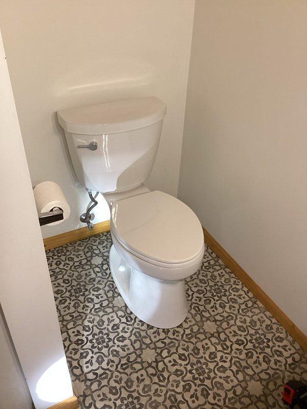 New Richmond, WI - Completed installation of customer-supplied toilet in small bathroom. Properly set and secured two-piece white toilet with chrome flush handle in corner location. Verified proper operation and ensured no leaks before completing service.