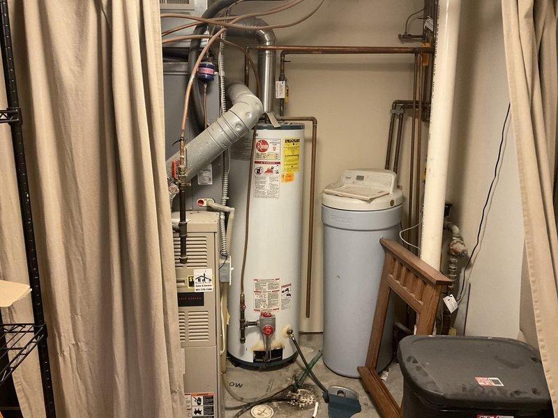 Replaced failed thermocouple on 2001 Rheem natural gas water heater that was not producing hot water. Noted significant buildup and corrosion on components. Due to the unit's age (22 years), recommended full water heater replacement as the more reliable long-term solution rather than continuing with component repairs.