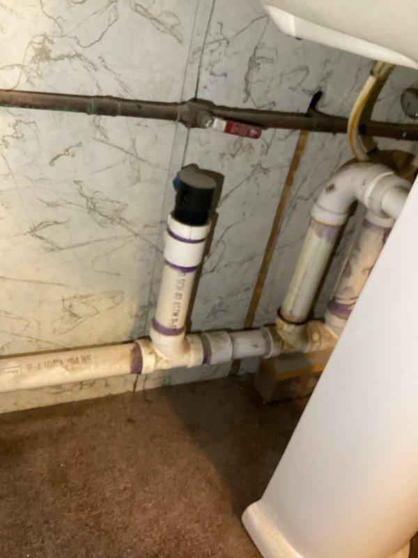 Investigated water leak report in basement near water heater. Performed comprehensive testing of all fixtures under high water loads but could not replicate the leak. Discovered water heater temperature was set excessively high at 150°F; adjusted to recommended 120°F to resolve potential pressure/expansion issues. Recommended installation of expansion tank to prevent future leaks, but customer declined this option.