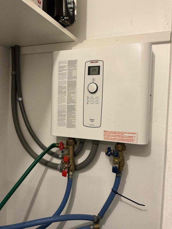 Diagnosed tankless water heater with limited hot water and malfunctioning water softener system. Inspection revealed softener was clogged and skipping regeneration cycles, while the water heater showed significant mineral buildup affecting performance. Provided options for water softener repair/replacement and tankless unit service to restore proper hot water function.