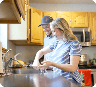Plumber and customer in front of sink