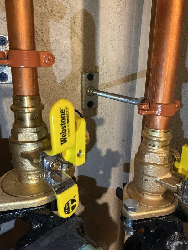 Responded to callback for insufficient hot water temperature at fixtures throughout residence. Upon arrival, measured water temperatures at multiple fixtures, confirming temperatures between 112-115°F, with shower and main bath showing inconsistent delivery. Investigation revealed mixing valve installed during previous recall service in January had never been properly adjusted and was set at full closed position, limiting output to 115°F. Adjusted mixing valve to proper setting and reconfigured selection parameters on IBC tankless water heater to optimize performance with mixing valve installation. Shower valve cartridge identified as additional source of temperature inconsistency; estimate provided for cartridge replacement to resolve remaining fluctuation issues and achieve desired water temperature for bathing applications.