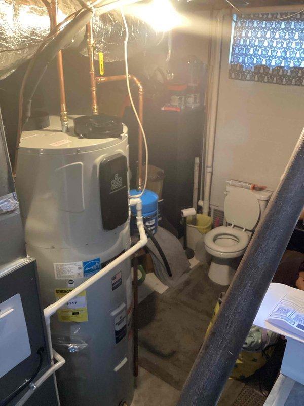 Responded to hybrid water heater displaying fault codes 96 (super heat failure) and 10 (super heat malfunction) with audible alarm. Unit was approximately two months old and experiencing recurring overheat conditions. Consulted with technical support to verify diagnosis and determine appropriate resolution. Replaced defective hybrid water heater with new unit per manufacturer warranty guidelines. Verified electric heating mode operational to maintain hot water supply during service. Documented installation with photographs showing new water heater positioned in basement utility area with proper connections to existing copper plumbing, PVC drainage, electrical panel, and HVAC ductwork. Advised homeowner that scheduling for previously delayed outside condenser work would be arranged at a later date once ground conditions permit proper installation.