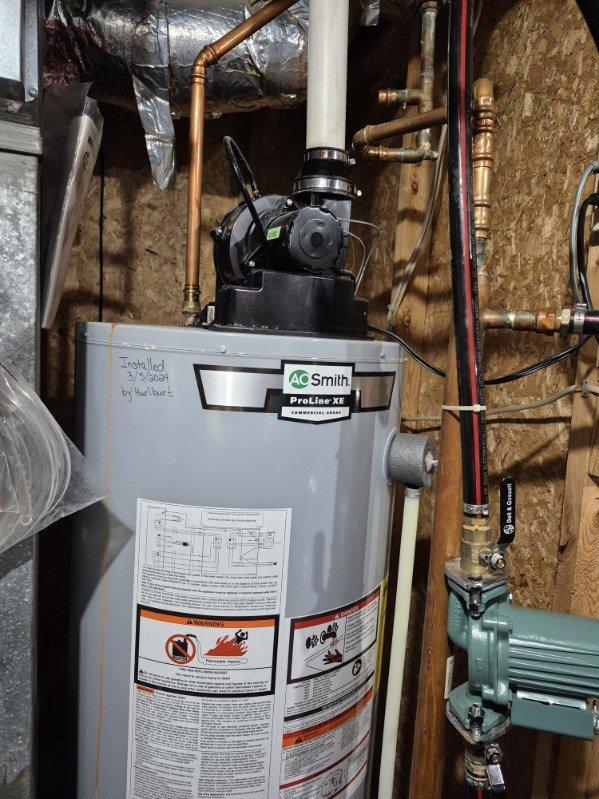 Replaced leaking 40-gallon LP water heater that showed significant corrosion at connection points. Installed new A.O. Smith ProLine XL commercial series water heater with proper copper piping and fittings, resolving the water leakage issue.