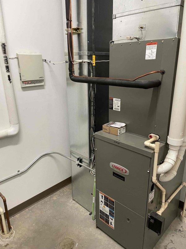 Inspected five HVAC units across the facility. Found two twinned furnaces for community room with frozen exhaust pipes on roof. Diagnosed garage hanging heater with blown 5 amp fuse and shorted control board requiring replacement. Resolved heating distribution issues in office areas by correcting thermostat settings from AC to heat mode and adjusted boiler control parameters. Identified additional maintenance needs including failing blower motor in Furnace 4 and leaking exhaust pipe connections on Furnace 3.