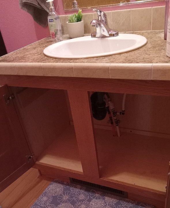 Diagnosed and resolved cold water supply issue in bathroom. Discovered leaking waterlines under the sink along with a compromised drain pipe. Repaired by reinstalling drain assembly and tightening a loose SharkBite fitting, restoring proper water flow and eliminating leaks.