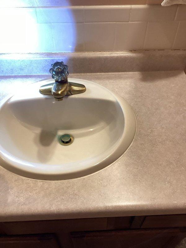 Conducted a plumbing inspection and identified a missing pipe causing seasonal leakage. Recommended replacement and capping of CPVC water line located above the furnace. Documented Payne HVAC system installation and bathroom fixtures, noting potential additional plumbing concerns throughout the property.