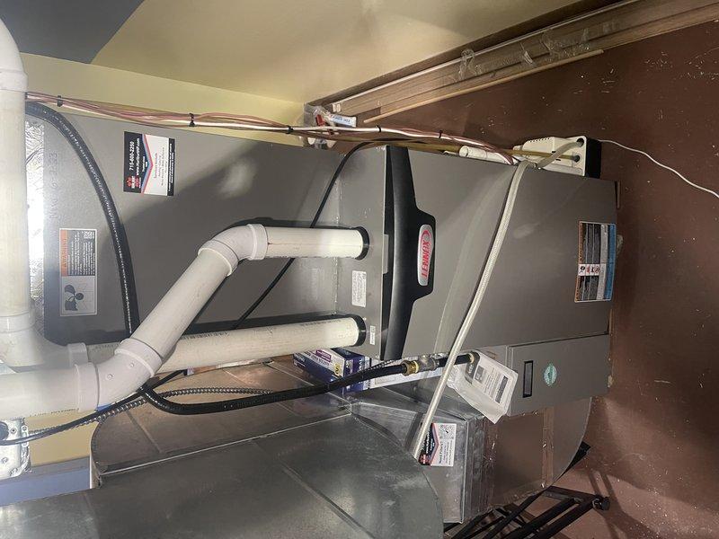 Installed Wi-Fi leak detector at customer's residence and reconfigured humidifier drainage system by implementing a single hose connection directly to the condensate pump. Set up safety shutoff mechanism to disable humidifier operation if pump fails to start, providing additional protection against water damage. All work completed successfully with photo documentation of the installation.