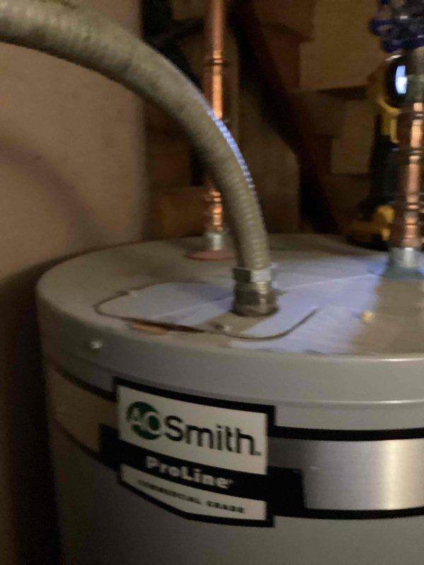 Conducted phone consultation regarding previous inspection findings. Homeowner approved repair plan to remove a section of CPVC piping that runs from the Soji to the furnace area and cap off the copper line connection. Documented existing A.O. Smith ProLine water heater installation and Payne HVAC system with associated plumbing connections for reference.