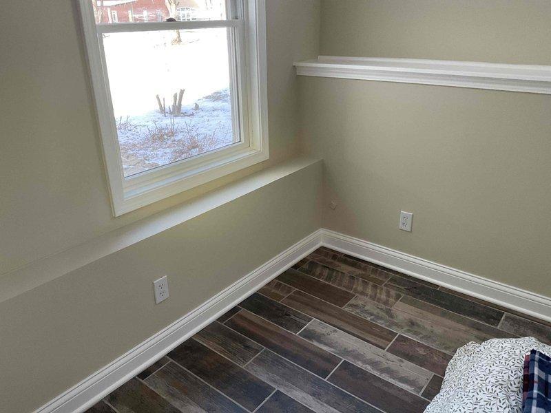 Responded to a service call for a garbage disposal causing sink backup. Upon inspection, determined both the main kitchen sink and vegetable sink drains were plugged. Further investigation revealed the drains connect in the lower level bedroom and drain through the exterior wall, where pipes appear to be frozen. Unable to service frozen exterior drain lines with available equipment; recommended and provided contact information for 4 Front Energy to address the issue.