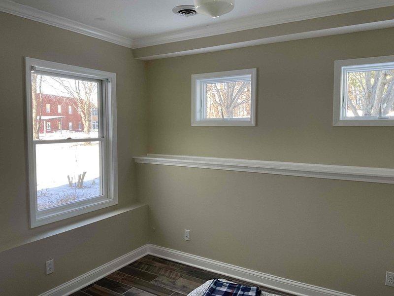 Responded to a service call for a garbage disposal causing sink backup. Upon inspection, determined both the main kitchen sink and vegetable sink drains were plugged. Further investigation revealed the drains connect in the lower level bedroom and drain through the exterior wall, where pipes appear to be frozen. Unable to service frozen exterior drain lines with available equipment; recommended and provided contact information for 4 Front Energy to address the issue.