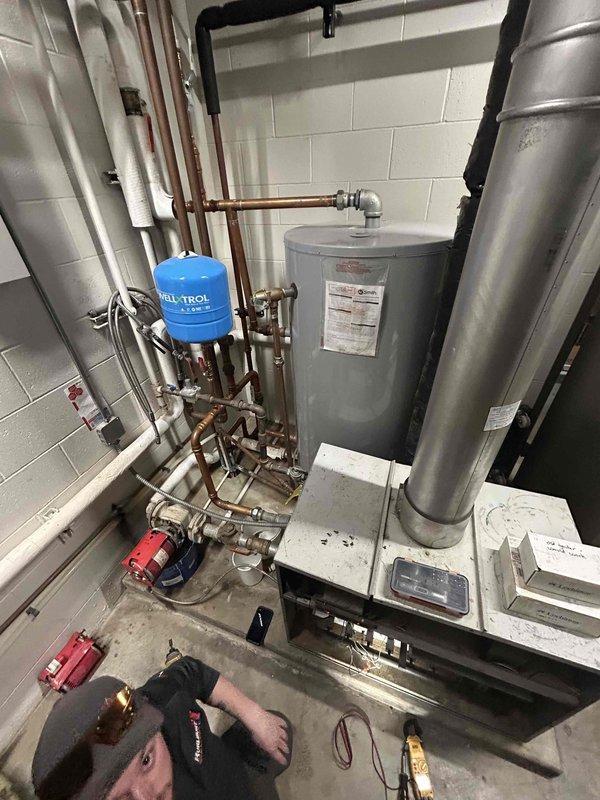 Responded to service call for Lochinvar boiler that was not producing hot water. Diagnosed issue as flame sense failure causing boiler to light and drop out; additionally discovered cracked pressure switch hose. Replaced pressure switch hose to restore temporary operation and recommended replacement ignitor, which has been ordered.