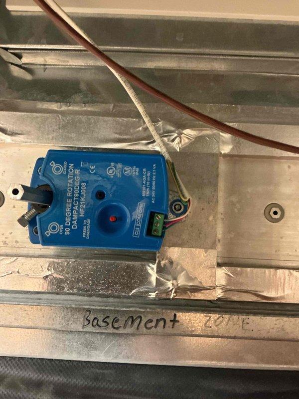Identified audible clicking noise coming from zone dampers on both furnaces. Inspection revealed 14-year-old zone motors repeatedly hitting end switches, causing the constant noise. Verified proper mounting and alignment of all components. Recommended replacement of the affected zone dampers and potentially all zone motors due to their age.