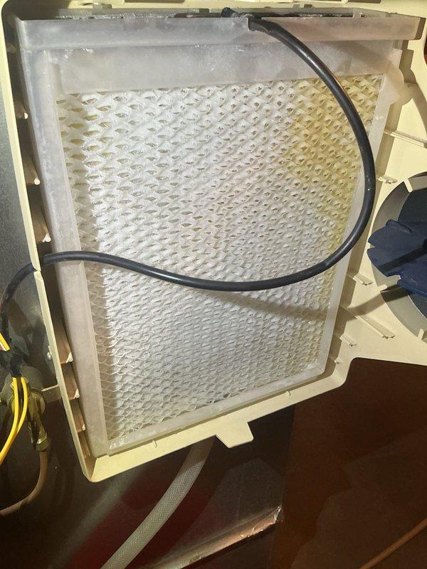 Responded to service call for two malfunctioning humidifiers in a 4Front PA Member's home where humidity had dropped to 20% causing floorboard separation. Inspected both units and determined the older humidifier was functioning properly after changing the water panel, while the newer unit required replacement of customer-supplied pad. Both systems were tested and confirmed operational with proper humidity restoration.