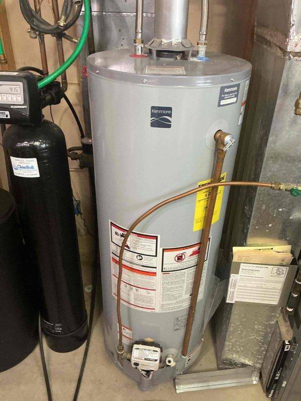 Responded to service call for non-functioning water heater. Diagnosed Kenmore unit with extinguished pilot light. Successfully relit pilot and restored hot water functionality. Noted significant corrosion on exterior plumbing valve that may require future attention.
