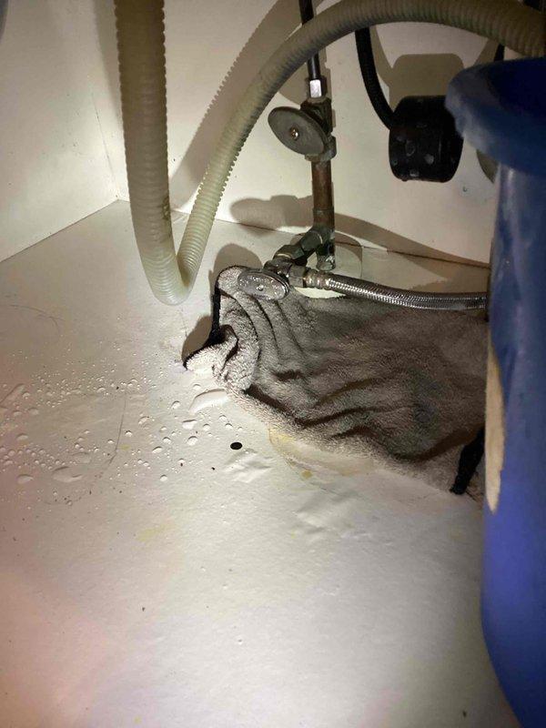 Responded to service call for kitchen sink clog. Removed drainpipes to access blockage and attempted to clear obstruction using drain snake. Despite multiple attempts, unable to successfully clear the clogged drain line. Documented existing plumbing configuration with photos showing drainage assembly and evidence of moisture.