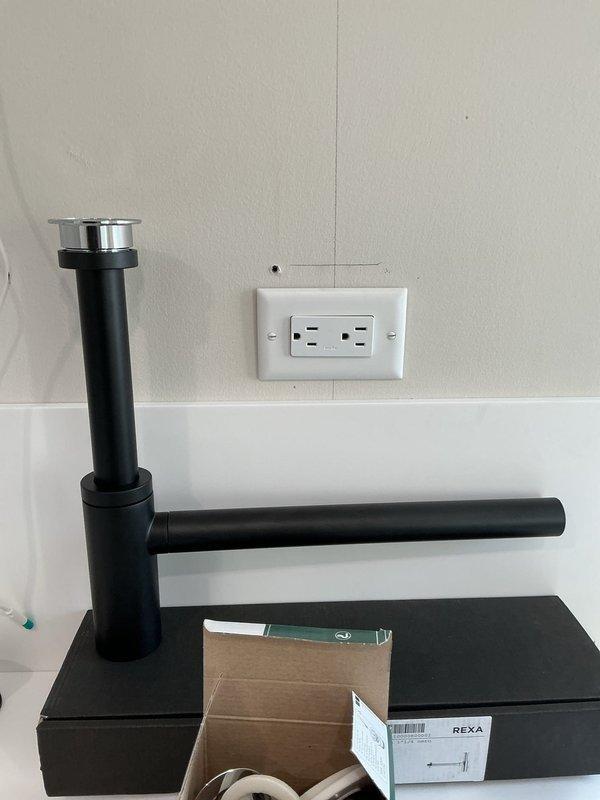 Completed installation of faucets in the second floor bathroom sink, including proper P-trap assembly and drainage connections. Successfully installed and connected all required PVC piping with appropriate metal clamps and secured the flexible drain hose system. All connections were verified for proper function with no leaks observed.