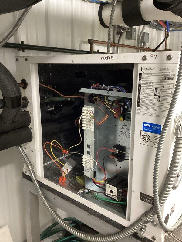 Diagnosed intermittent operation of geothermal system at commercial office. Inspection revealed low refrigerant levels causing insufficient temperature differential (20° across air handler coil, 2° across coax in heating mode). Added approximately one pound of refrigerant and tightened all service ports, particularly addressing a leaking discharge line port with visible oil residue. Post-repair testing confirmed proper operation with improved temperature rise (30°) and appropriate pressure readings (100 psi low side, 370 psi high side).