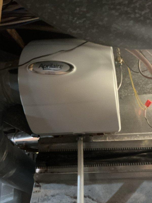 Responded to ongoing humidity complaint causing floorboard separation issues. Inspected Aprilaire humidifier system which was functioning properly; slightly adjusted settings upward to increase humidity output. Advised customer to expect gradual improvement by spring. Also documented Rheem water heater installation as part of home's overall humidity management system.