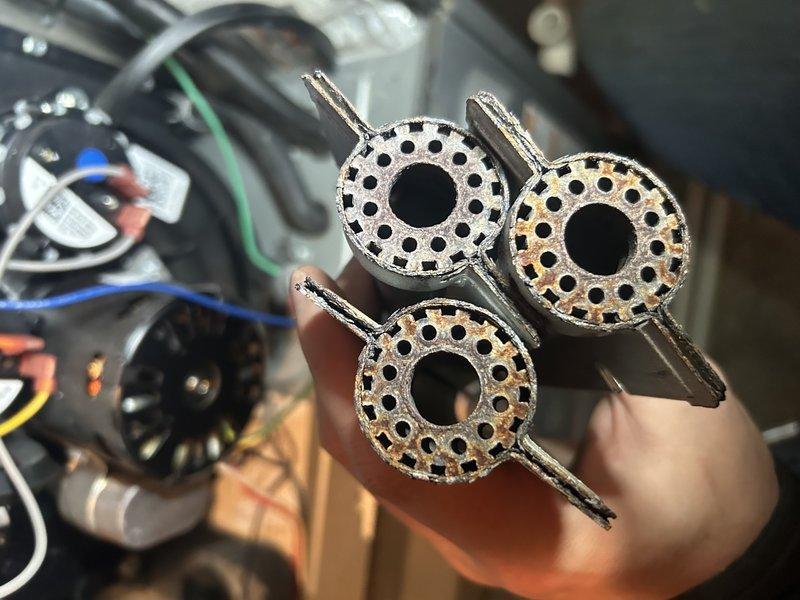 Diagnosed LP furnace with flame sensor issue indicated by 7 red blinking lights. Inspection revealed significantly plugged burners affecting consistent ignition across all ports. Replaced burners, cleaned flame sensor, and verified proper operation with good temperature readings.