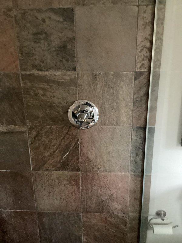 River Falls, WI - Replaced leaking shower valve in tiled bathroom. Removed old chrome valve assembly that was leaking from shutoffs, and installed new valve fixture. Complete replacement required 3-4 hours of labor to access valve behind tile wall, make necessary plumbing connections, and ensure proper operation with no leaks.